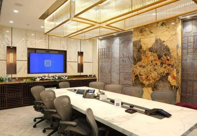 High-end boardroom featuring a large marble table and integrated technology.