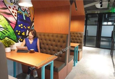 Lounge area featuring tufted leather booth seating and colorful wall art.