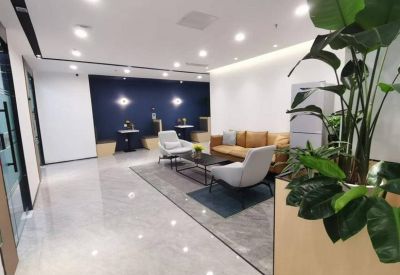 Stylish reception lounge with a blue accent wall, comfortable seating, and polished floors.