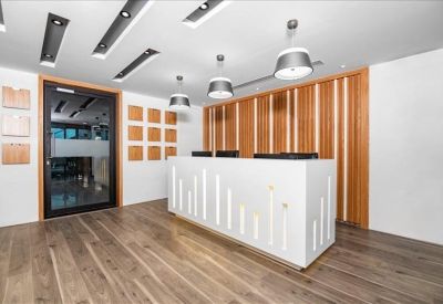 Professional reception area with white desk and wood-slat feature wall.