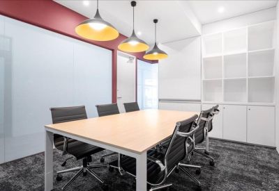 Meeting room with modern pendant lighting and white storage cabinetry.
