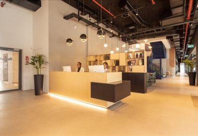 Sleek reception desk with warm under-lighting and decorative pendant lamps.