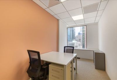 Private office with two desks and a bright window overlooking the city.