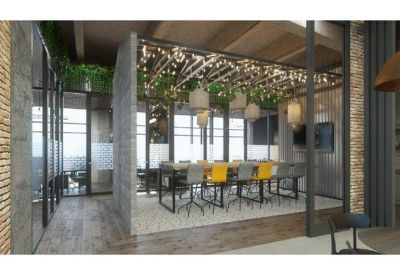 Meeting room with a long wooden table and decorative overhead lights wrapped in greenery.