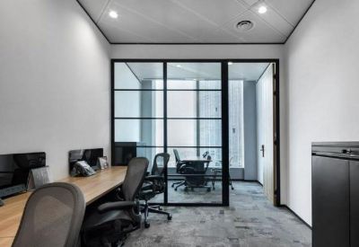 Sleek private office suite with glass partitioning and ergonomic black workstations.