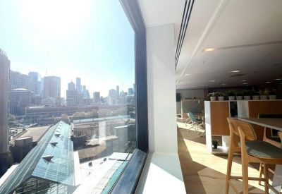 Modern break area featuring high-top seating and views of the city skyline.
