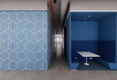 Professional meeting room with a large white table, blue walls, and motivational text.