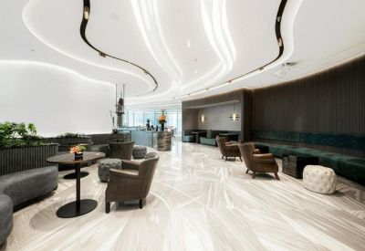 Spacious lounge area featuring curved light fixtures and plush seating.