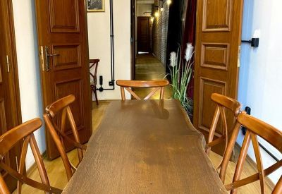 Meeting room with a long live-edge wooden table and classic wooden chairs.