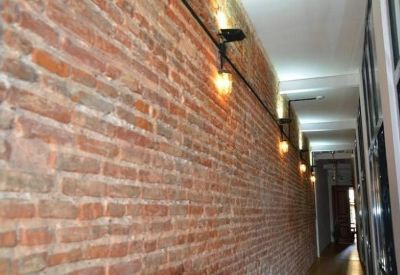 Exposed brick hallway at Istiklal Cd. 189 Tomtom Mh. Beyoğlu, Istanbul with warm pendant lighting.