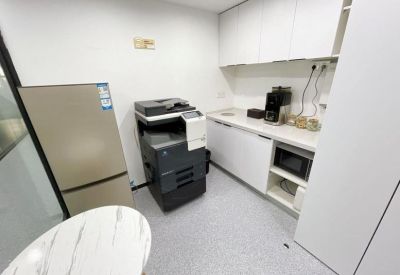 Communal kitchen area with coffee machine, microwave, and mini-fridge.