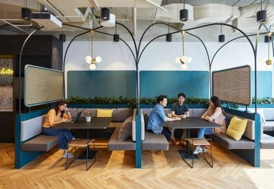 Arched booth seating with teal accent walls and pendant lighting.