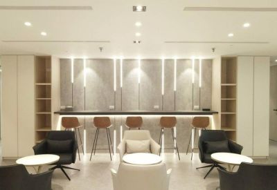 Modern lounge area with bar seating and glowing wall accents.