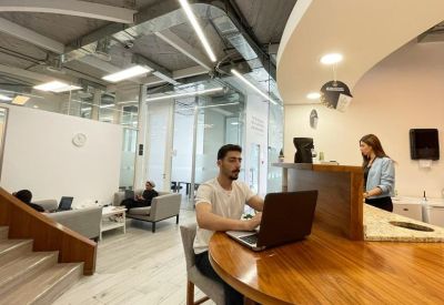 Communal breakout area with a wooden curved counter and comfortable lounge seating.