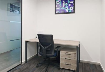 Private single-desk office featuring a mobile filing cabinet and blue-patterned wall art.