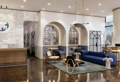 Elegant reception area with wooden front desk and arched wall features.