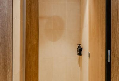 Contemporary kitchen with dark green cabinetry and stone countertops.