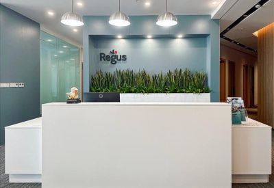 Reception desk with plants and pendant lights.
