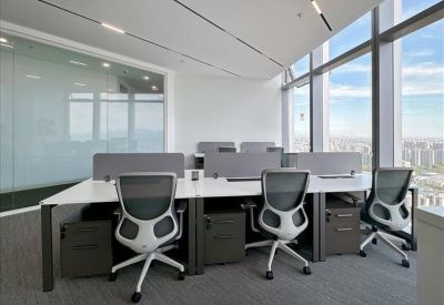 Open-plan workspace with shared desks and natural light.