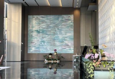 Spacious lobby area with a large abstract blue painting on a feature wall.