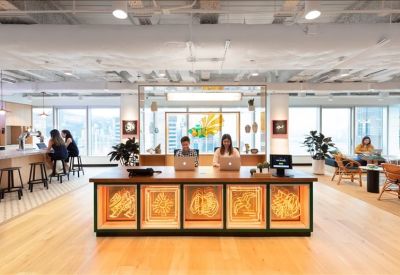 Reception desk featuring warm backlighting and wood finishes with a view of the pantry.