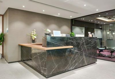 Professional reception area featuring a dark marble desk with white veining.