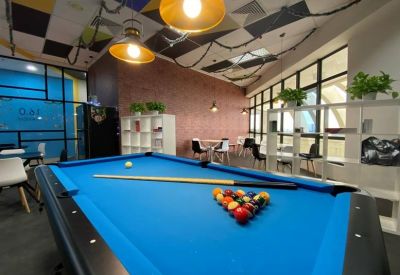 Breakout area featuring a blue pool table and warm pendant lighting.