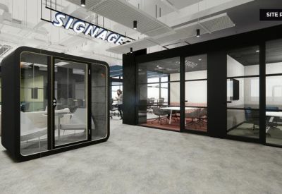 Modern black soundproof phone booth in an open-plan office.