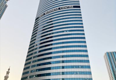 Exterior view of the curved glass facade of HDS Tower in the daytime.