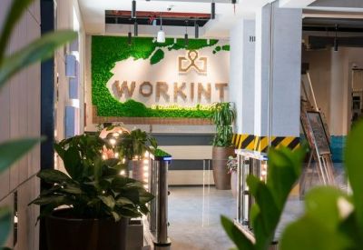 Reception entrance featuring a lush green moss wall with branded signage.