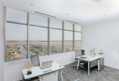Private windowed office with two white desks and views overlooking the city landscape.