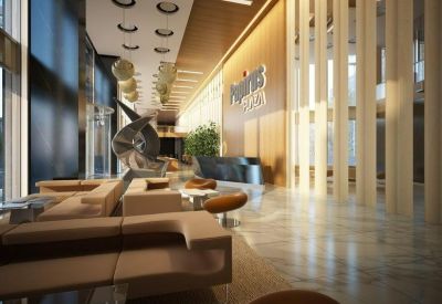Spacious modern lobby with high ceilings, feature lighting and wooden wall panels.