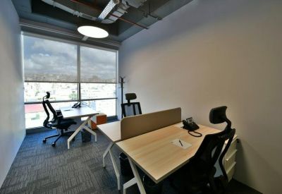 Private office for two with adjustable chairs and a large window overlooking the city.