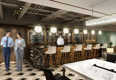 Modern communal breakout space with a wooden bar, white stools, and decorative globe lighting.