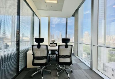 Sleek glass-walled office with ergonomic chairs and views of the urban skyline.