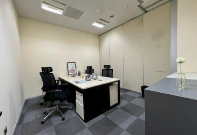 Private internal meeting room featuring a white table and black leather chairs.