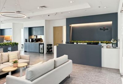 Sleek professional reception desk in grey and white with integrated lighting and soft seating area.