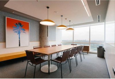 Professional meeting room with a long wooden table, leather chairs, and large windows.