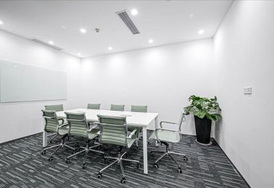Clean white kitchen area with integrated appliances, sleek cabinetry, and a refrigerator.