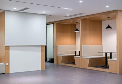 Professional white reception desk with a backlit Regus logo on the back wall.
