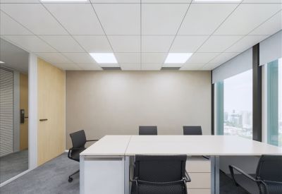 Private office space with wooden door and light gray walls.