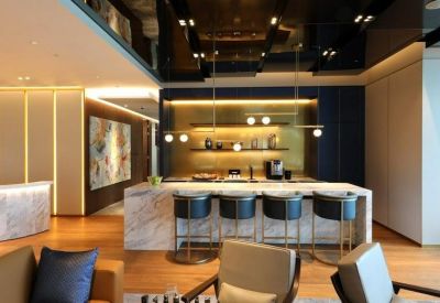 Sophisticated communal lounge with a marble breakfast bar and dark polished ceilings.