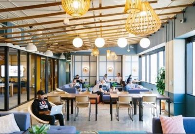 Casual seating area with large windows and ample lighting.