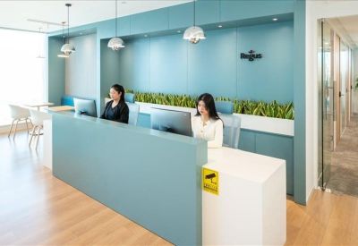 Modern reception desk with blue accents and warm lighting.