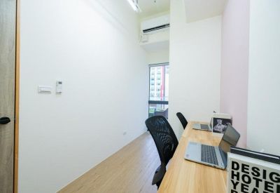 Bright private office suite with two workstations, ergonomic chairs, and a window.