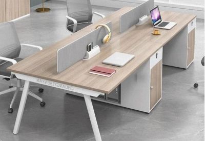 Minimalist workstation setup with a light oak tabletop and light grey privacy dividers.