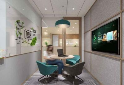 Private four-person meeting room with teal chairs, a whiteboard, and a wall-mounted TV.