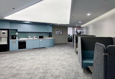 Communal kitchen area with seating and appliances.