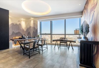 Sun-drenched executive lounge with traditional wooden furniture and a large window.