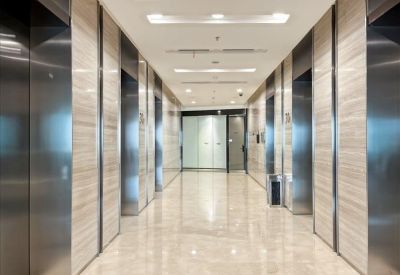Polished elevator lobby with marble-tiled walls and reflective flooring.